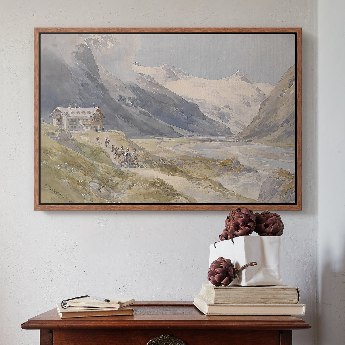 Walnut floater framed canvas featuring Shepherds (Pasterze), c. 1921 by Edward Theodore Compton above an entryway table in a minimalist foyer.