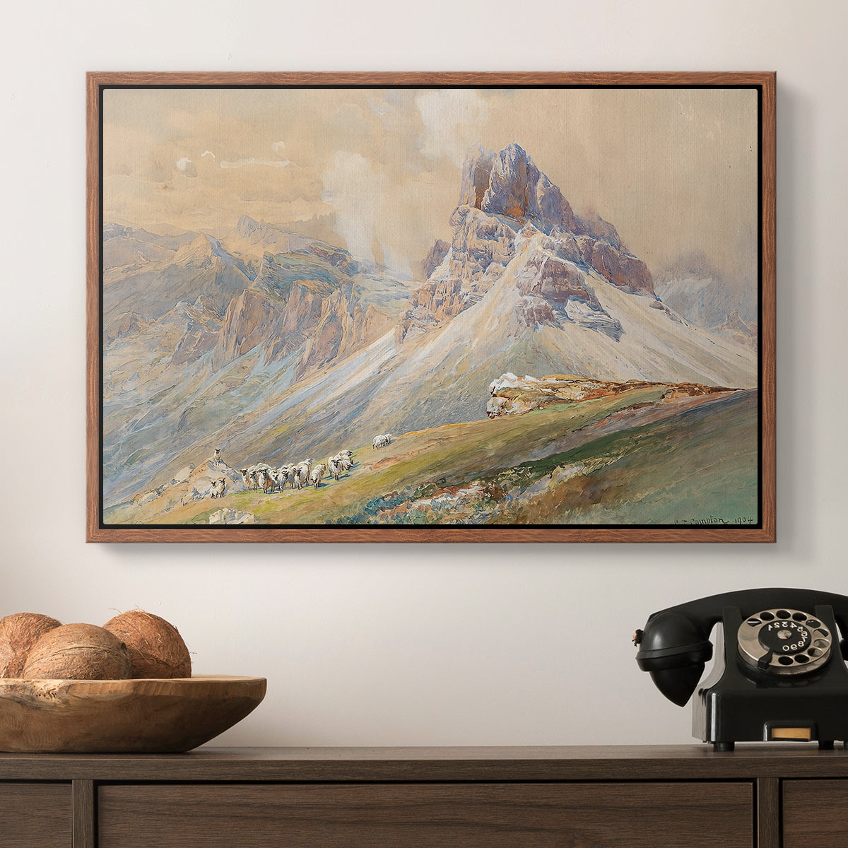 From the Dolomites, 1904 by Edward Theodore Compton in a walnut floater framed canvas displayed above a console table in a hallway, featuring a realistic mountain view with strong geological forms.