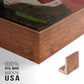 Close-up of the walnut floater frame corner and gallery wrapped canvas construction.