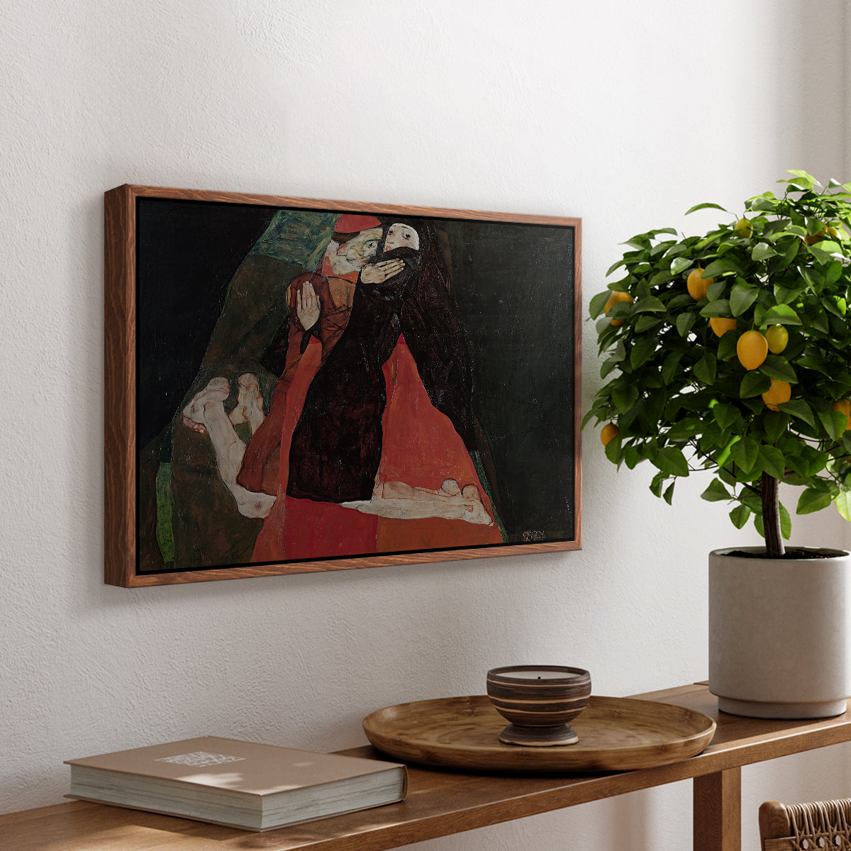 Cardinal and Nun (Caress), 1912 by Egon Schiele, presented in a walnut floater framed canvas featuring two figures embracing intimately in stylized expressionist composition, displayed above a hallway console table.