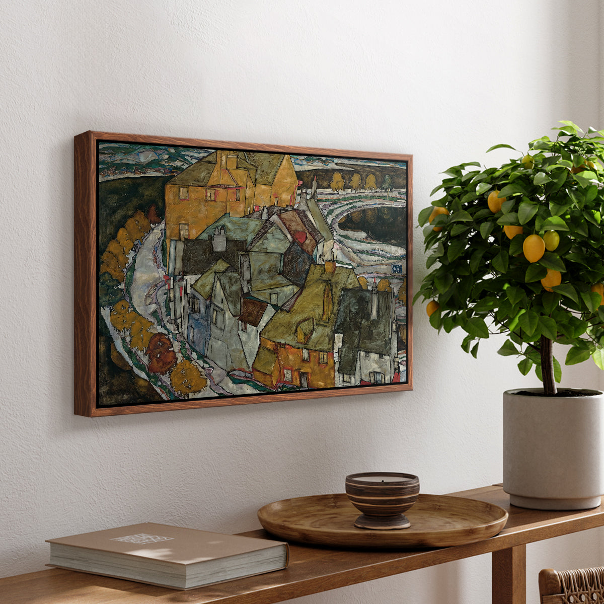 Crescent of Houses II (Island Town), 1915 by Egon Schiele, presented in a walnut floater framed canvas featuring a curved row of colorful houses forming crescent shape along water, displayed above a hallway console table.