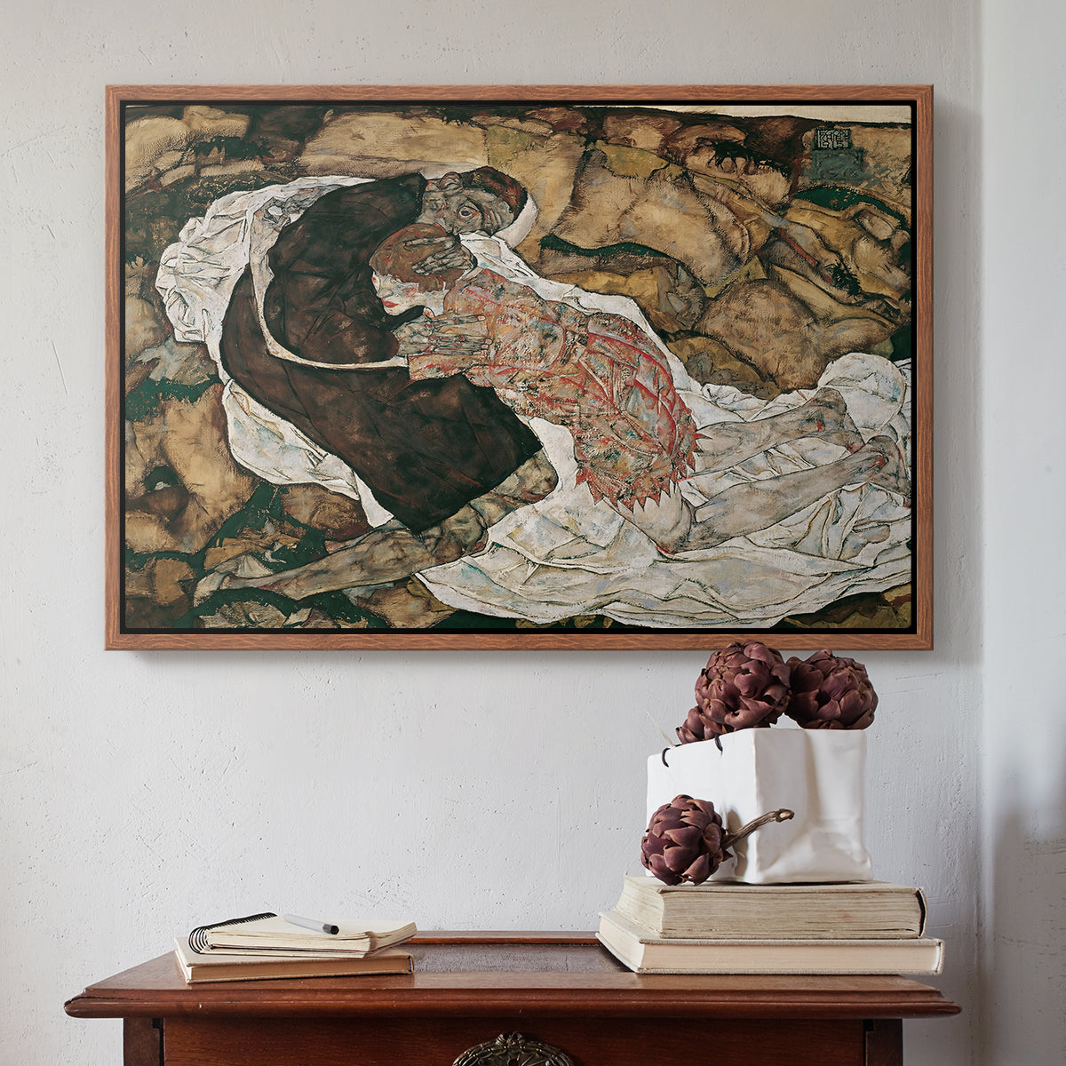 Walnut floater framed canvas featuring Death and the Maiden, 1915 by Egon Schiele above an entryway table in a minimalist foyer.