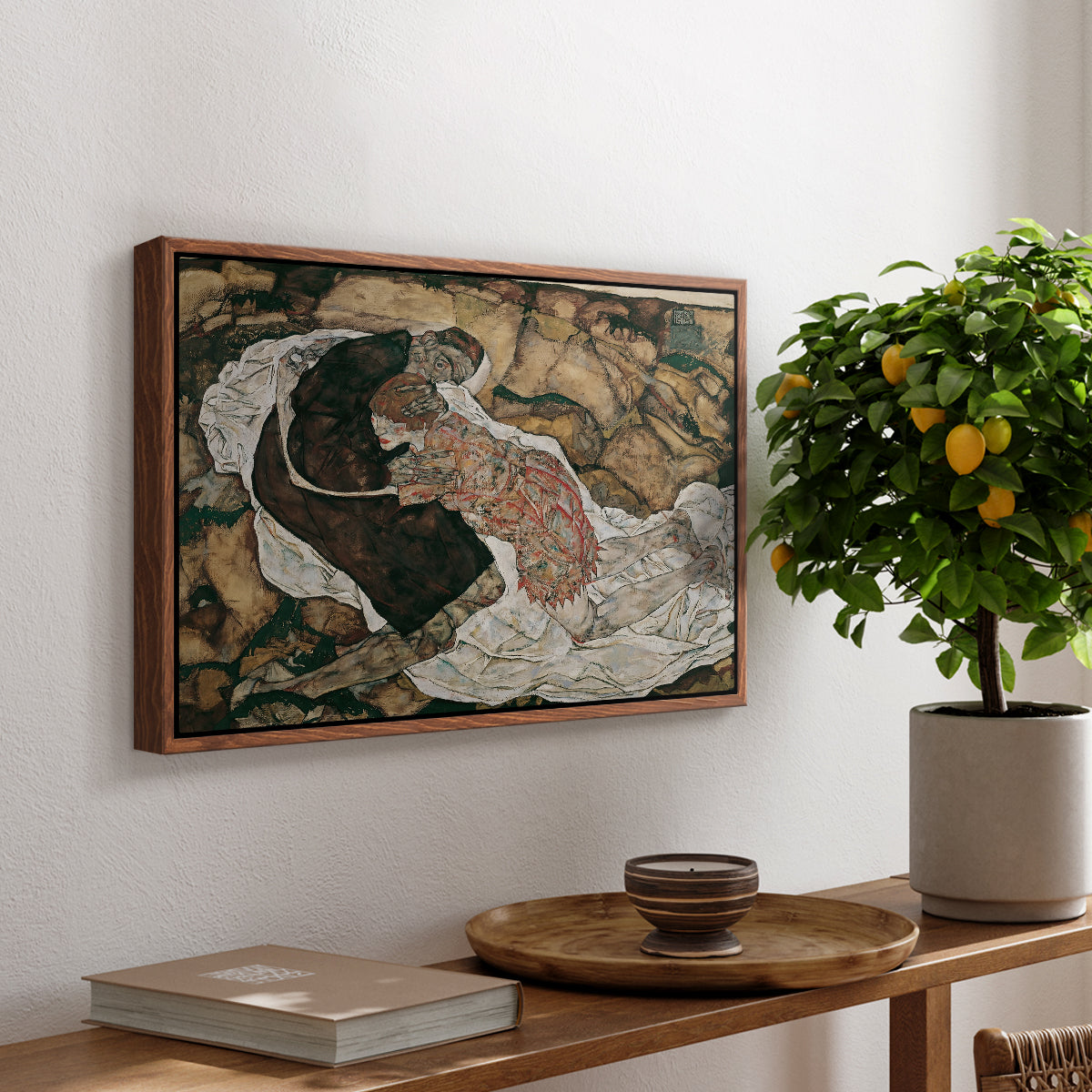 Death and the Maiden, 1915 by Egon Schiele, presented in a walnut floater framed canvas featuring intertwined figures representing death and woman in emotional embrace, displayed above a hallway console table.