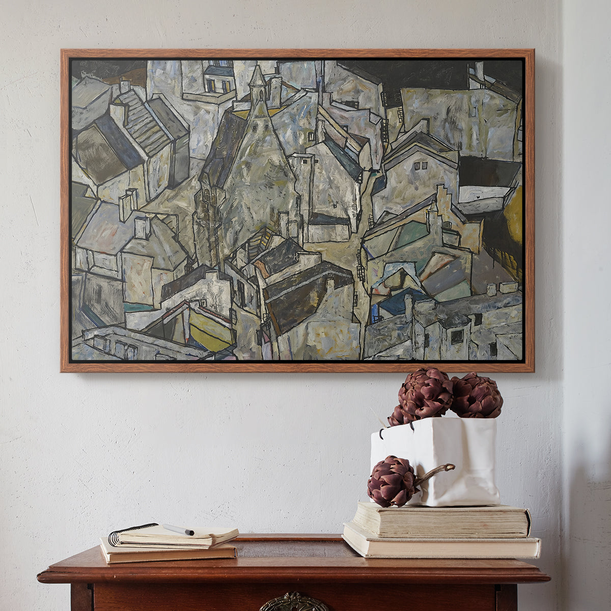 Walnut floater framed canvas featuring Mödling II, 1918 by Egon Schiele above an entryway table in a minimalist foyer.