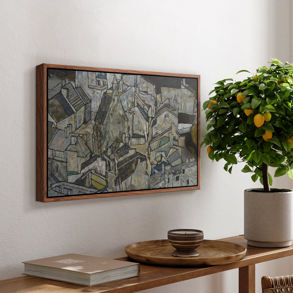 Mödling II, 1918 by Egon Schiele, presented in a walnut floater framed canvas featuring clustered geometric houses forming dense urban landscape with sharp angles, displayed above a hallway console table.