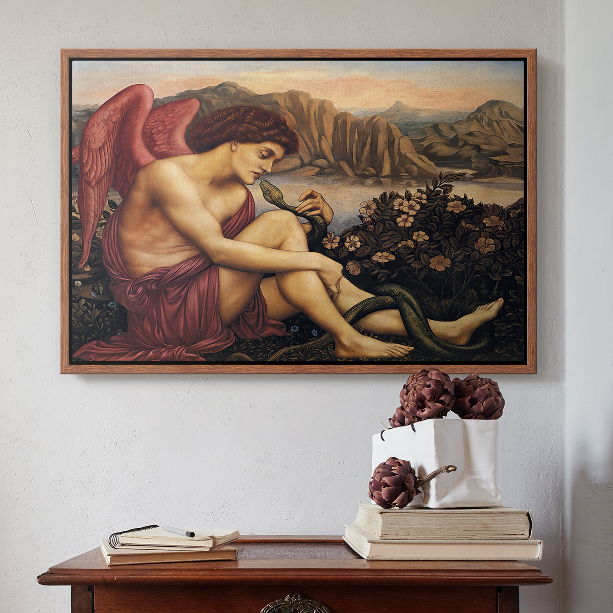 Walnut floater framed canvas featuring The Angel with the Serpent, c. 1870-1875 by Evelyn De Morgan above an entryway table in a minimalist foyer.