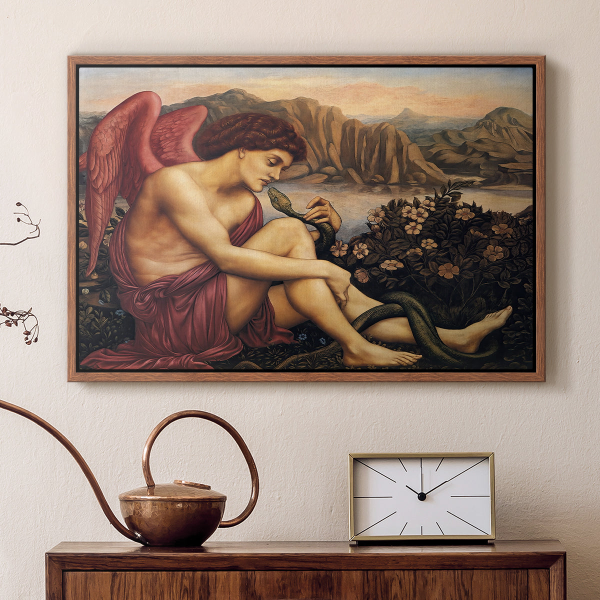 Walnut floater framed canvas featuring a religious scene with angel defeating snake in dramatic pose, displayed above a cabinet in a soft-toned living room.