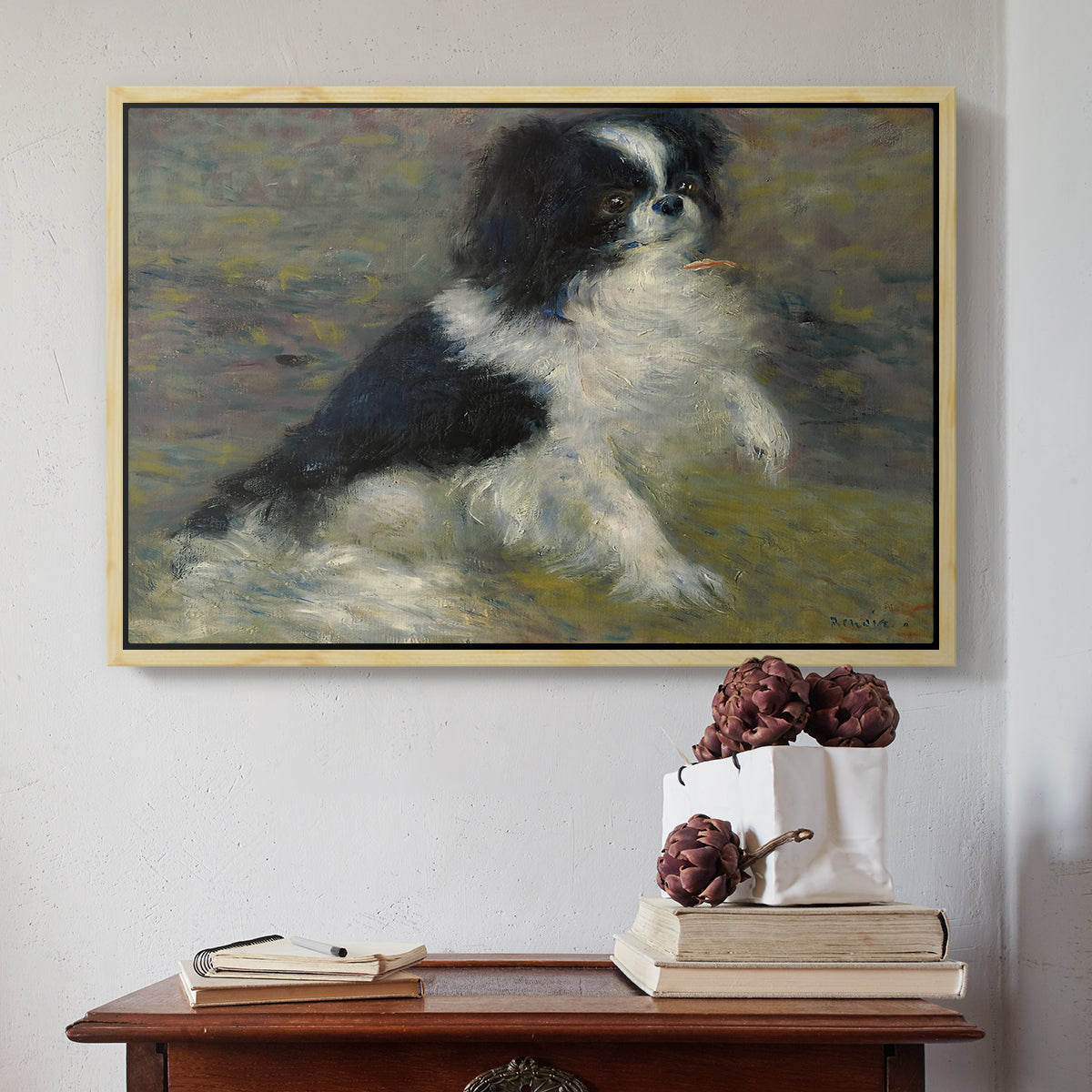 Natural wood floater framed canvas featuring Tama, the Japanese Dog, c. 1876 by Pierre-Auguste Renoir above an entryway table in a minimalist foyer.
