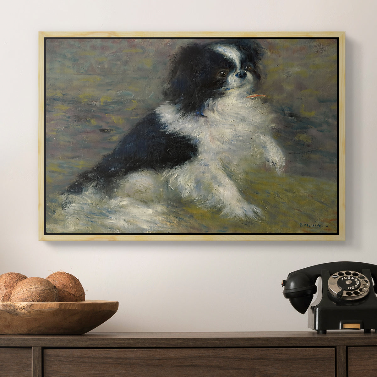 Tama, the Japanese Dog, c. 1876 by Pierre-Auguste Renoir in a natural wood floater framed canvas displayed above a console table in a hallway, featuring an animal portrait of a dog in natural outdoor setting with soft light.