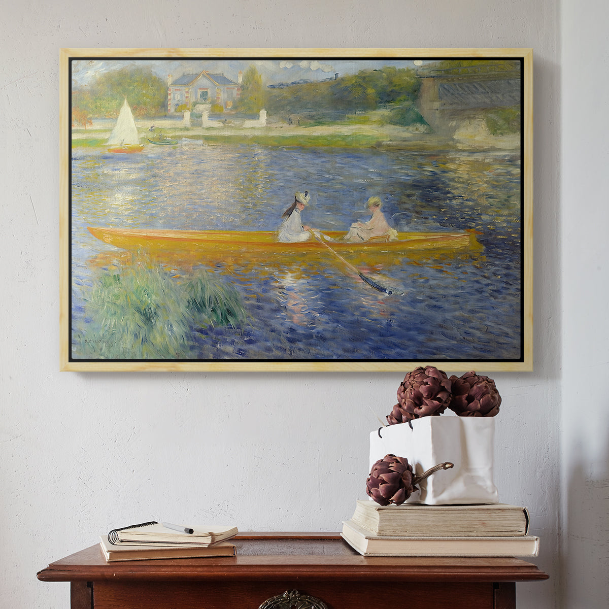 Natural wood floater framed canvas featuring The Skiff (La Yole), 1875 by Pierre-Auguste Renoir above an entryway table in a minimalist foyer.