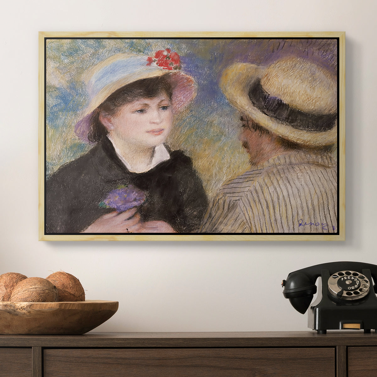 Boating Couple (Aline Charigot and Renoir), c. 1881 by Pierre-Auguste Renoir in a natural wood floater framed canvas displayed above a console table in a hallway, featuring a romantic scene of two figures in casual conversation with soft light.