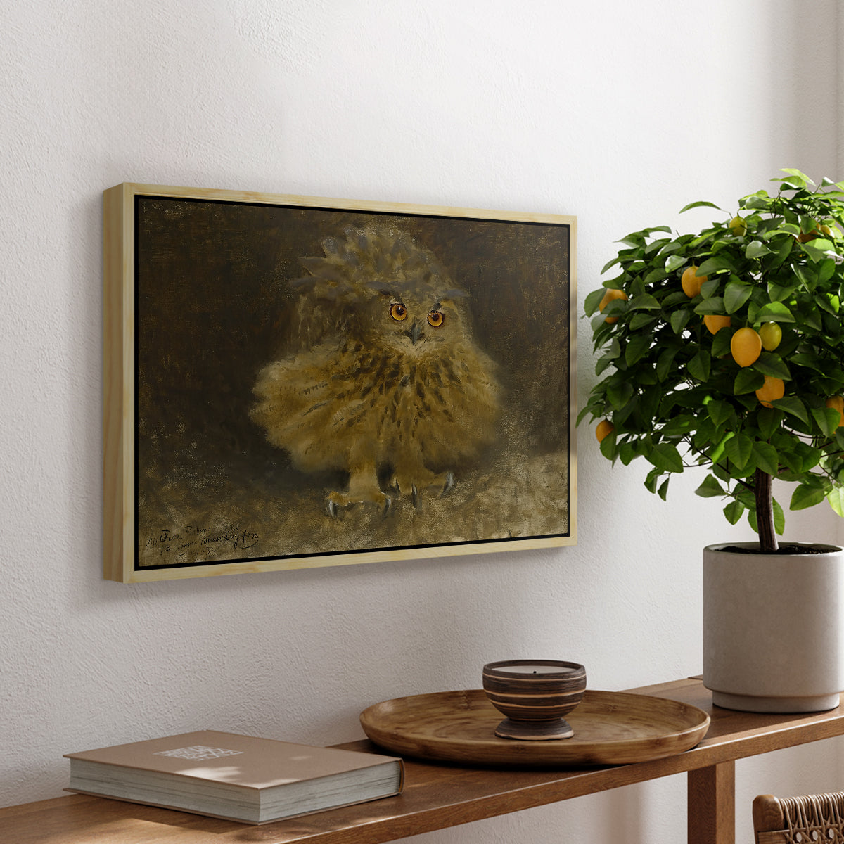 An Eagle Owl (Berguv), 1905 by Bruno Liljefors, presented in a natural wood floater framed canvas featuring a large owl perched on branch in shadowy natural forest setting, displayed above a hallway console table.