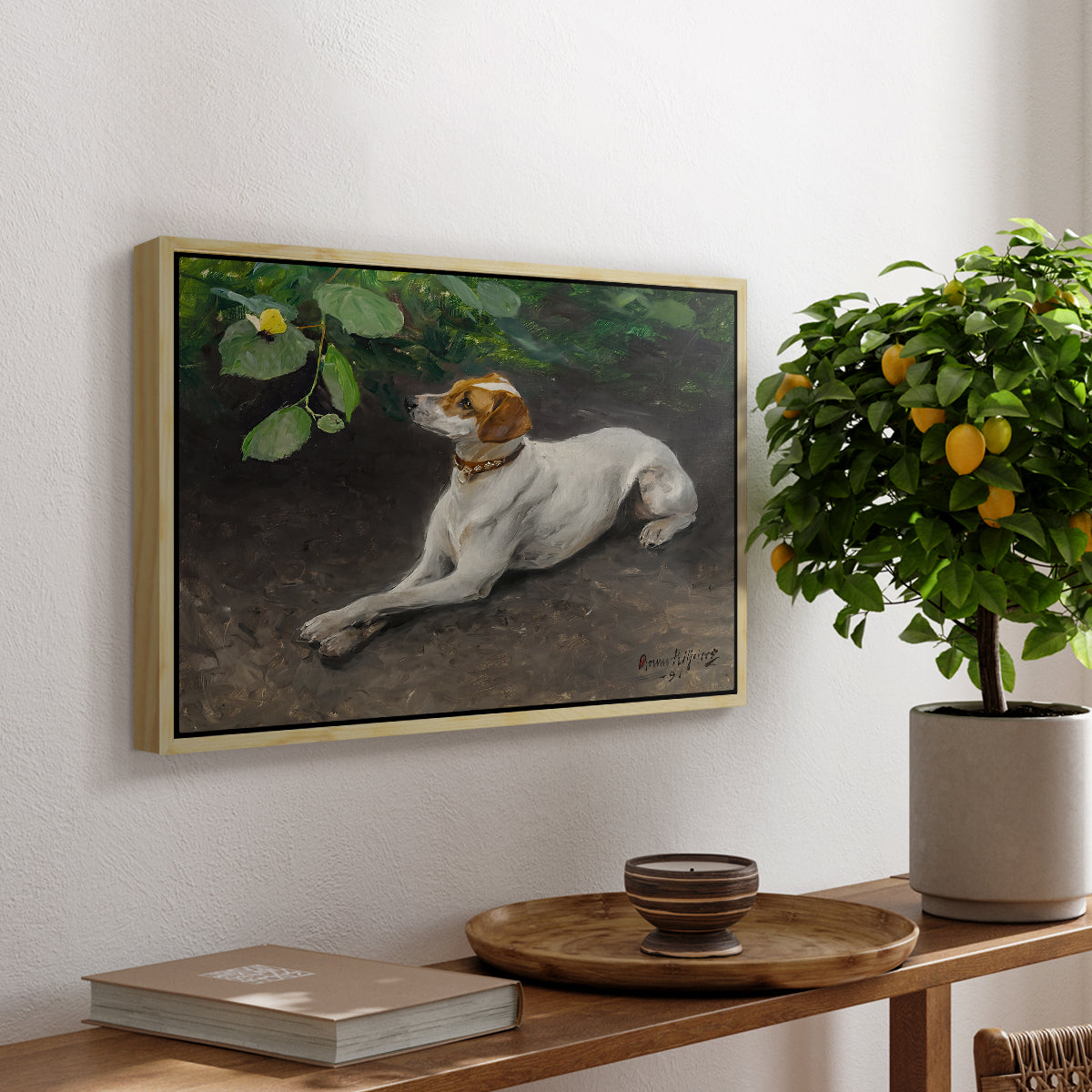 Portrait of a Dog, 1891 by Bruno Liljefors, presented in a natural wood floater framed canvas featuring a dog lying on ground with head raised in natural outdoor setting, displayed above a hallway console table.