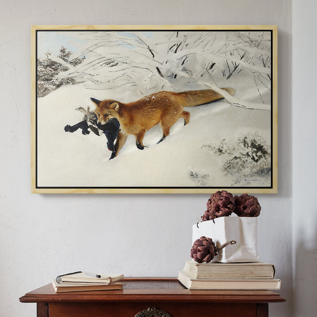 Natural wood floater framed canvas featuring Fox in Snow Landscape, 1900 by Bruno Liljefors above an entryway table in a minimalist foyer.