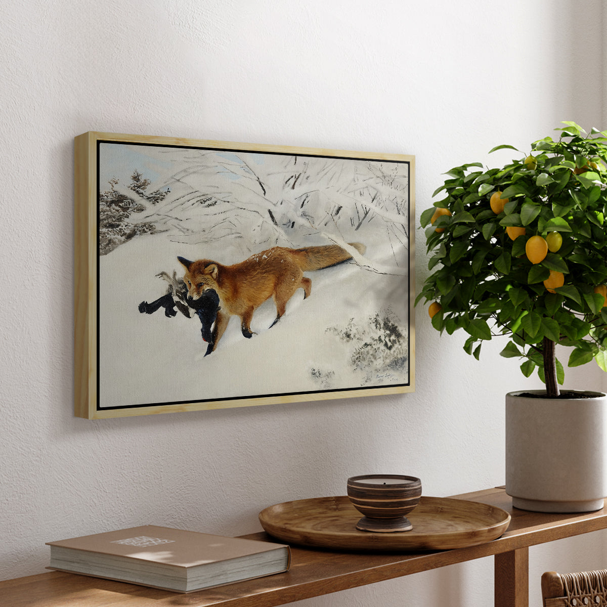 Fox in Snow Landscape, 1900 by Bruno Liljefors, presented in a natural wood floater framed canvas featuring a fox running across snowy landscape with sparse vegetation, displayed above a hallway console table.