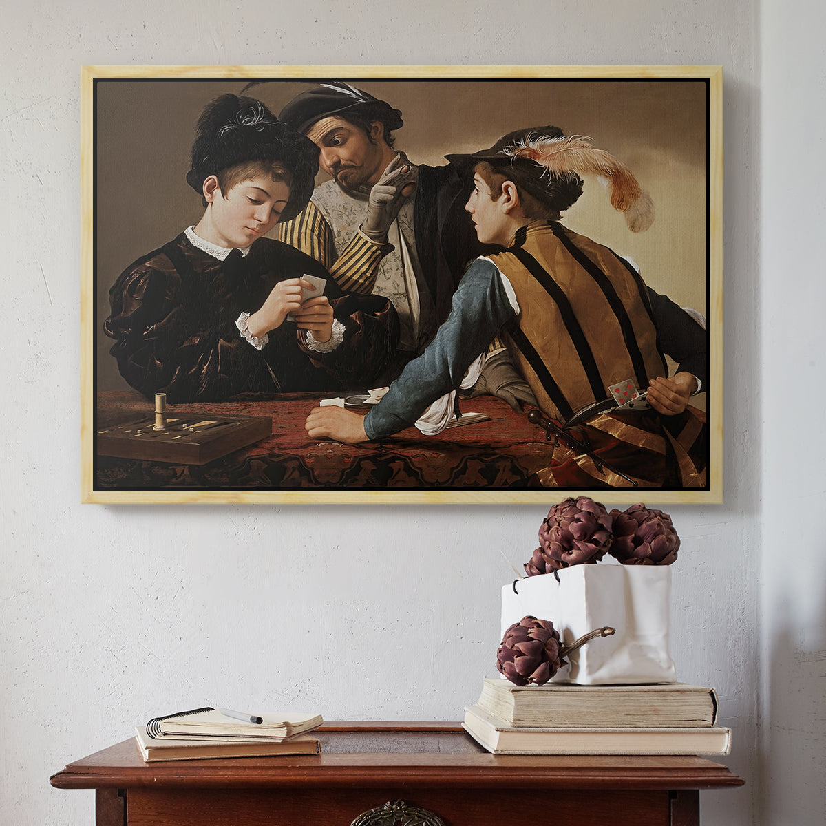 Natural wood floater framed canvas featuring The Cardsharps, c. 1594 by Caravaggio above an entryway table in a minimalist foyer.