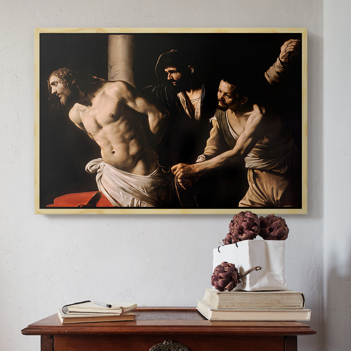 Natural wood floater framed canvas featuring The Flagellation of Christ at the Column (Rouen Version), 1606 by Caravaggio above an entryway table in a minimalist foyer.