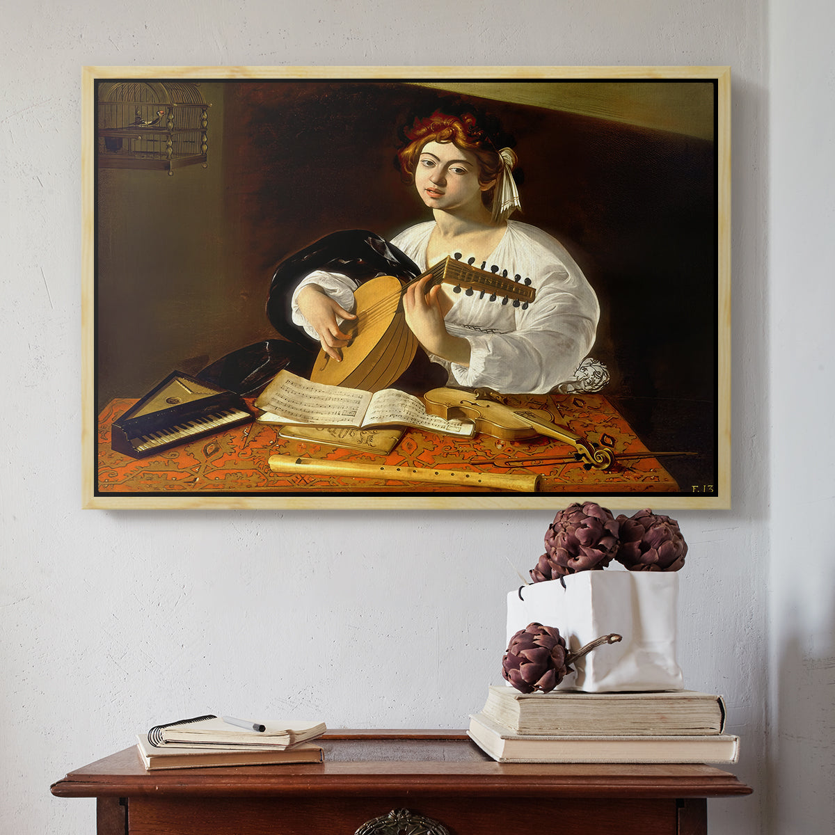 Natural wood floater framed canvas featuring The Lute Player (Wildenstein Version), c. 1596 by Caravaggio above an entryway table in a minimalist foyer.