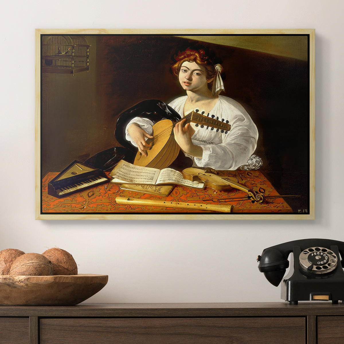 The Lute Player (Wildenstein Version), c. 1596 by Caravaggio in a natural wood floater framed canvas displayed above a console table in a hallway, featuring an intimate portrait of musician with still life elements.