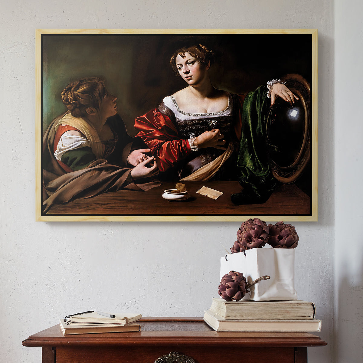 Natural wood floater framed canvas featuring Martha and Mary Magdalene, c. 1598 by Caravaggio above an entryway table in a minimalist foyer.