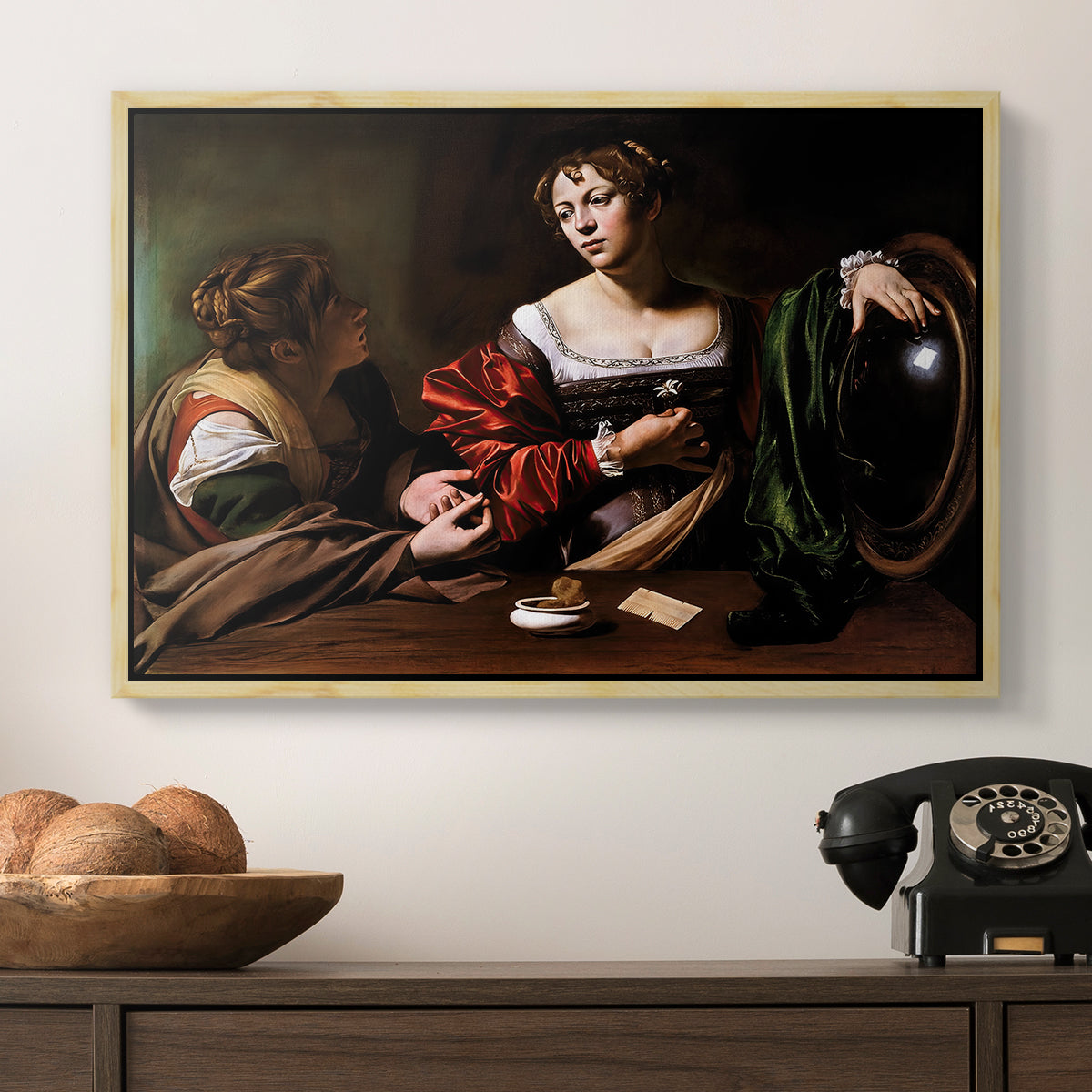 Martha and Mary Magdalene, c. 1598 by Caravaggio in a natural wood floater framed canvas displayed above a console table in a hallway, featuring a religious interior scene with figures engaged in thoughtful dialogue.