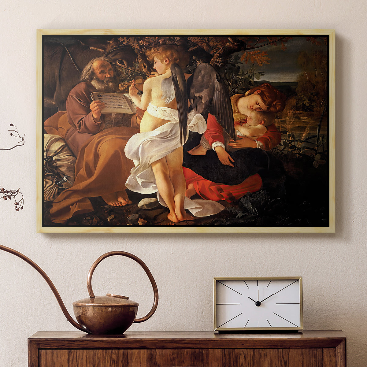 Natural wood floater framed canvas featuring a peaceful religious moment with figures reclining in natural setting, displayed above a cabinet in a soft-toned living room.
