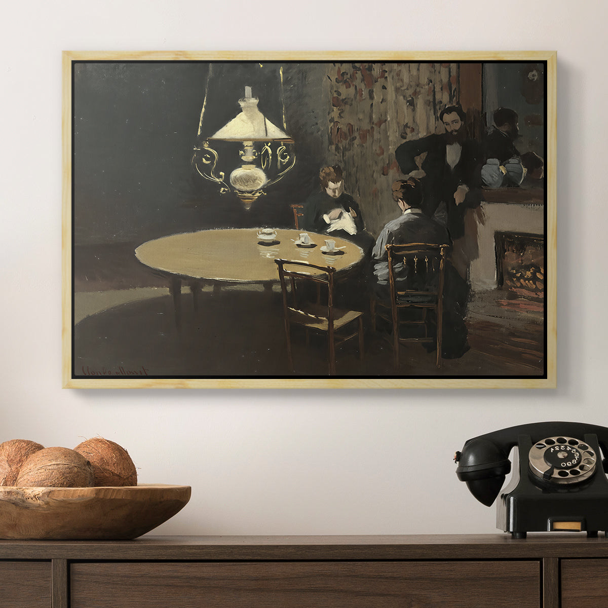 Interior, after Dinner, 1868-1869 by Claude Monet in a natural wood floater framed canvas displayed above a console table in a hallway, featuring an intimate indoor scene with figure and table in low lighting.