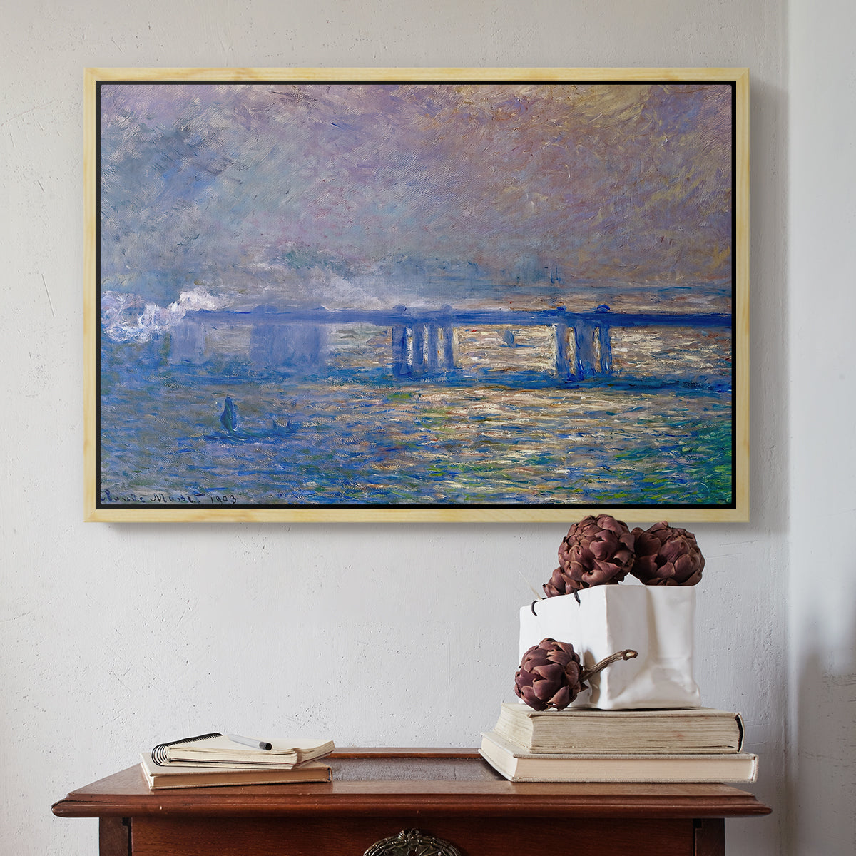Natural wood floater framed canvas featuring Charing Cross Bridge, 1903 by Claude Monet above an entryway table in a minimalist foyer.