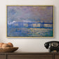 Charing Cross Bridge, 1903 by Claude Monet in a natural wood floater framed canvas displayed above a console table in a hallway, featuring a city bridge scene softened by mist and impressionist brushwork.