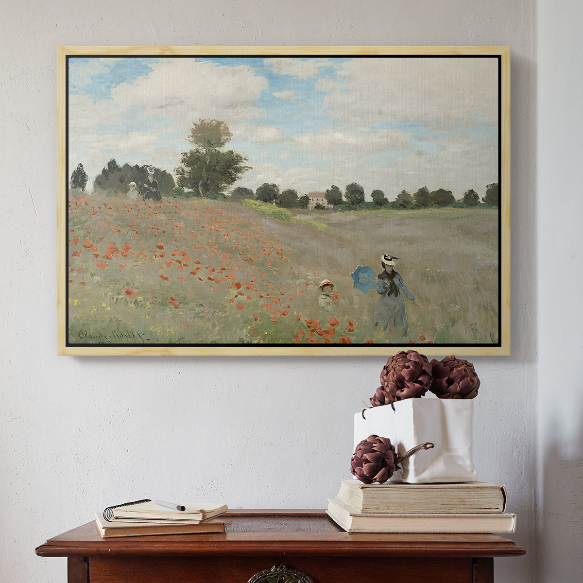 Natural wood floater framed canvas featuring The Poppy Field near Argenteuil, 1873 by Claude Monet above an entryway table in a minimalist foyer.