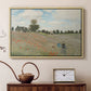 Natural wood floater framed canvas featuring a bright meadow filled with poppies under open sky, displayed above a cabinet in a soft-toned living room.