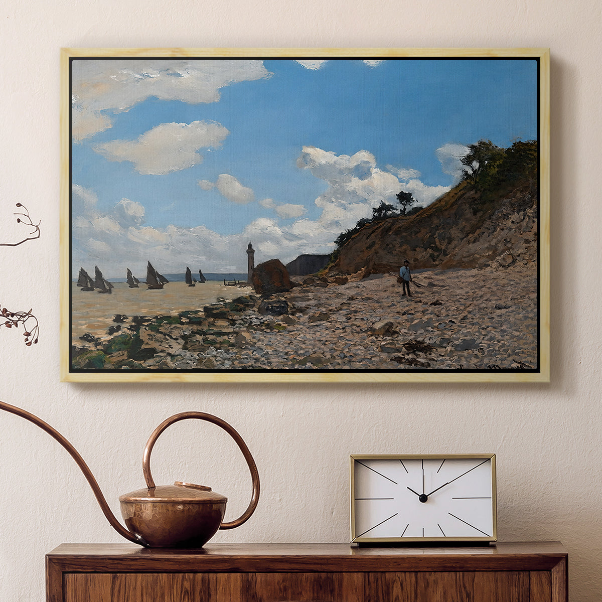 Natural wood floater framed canvas featuring a sandy beach with figures relaxing near water's edge, displayed above a cabinet in a soft-toned living room.