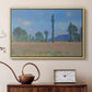 Natural wood floater framed canvas featuring a vibrant meadow scene with flowers and vertical tree forms, displayed above a cabinet in a soft-toned living room.