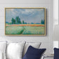 The Wheat Field (Champ de Blé), 1881 by Claude Monet displayed above a sofa in a living room in a natural wood floater frame, featuring an impressionist depiction of ripened grain field in countryside.