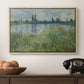 Banks of the Seine, Vétheuil, 1880 by Claude Monet in a natural wood floater framed canvas displayed above a console table in a hallway, featuring a natural landscape with calm water and soft foliage.