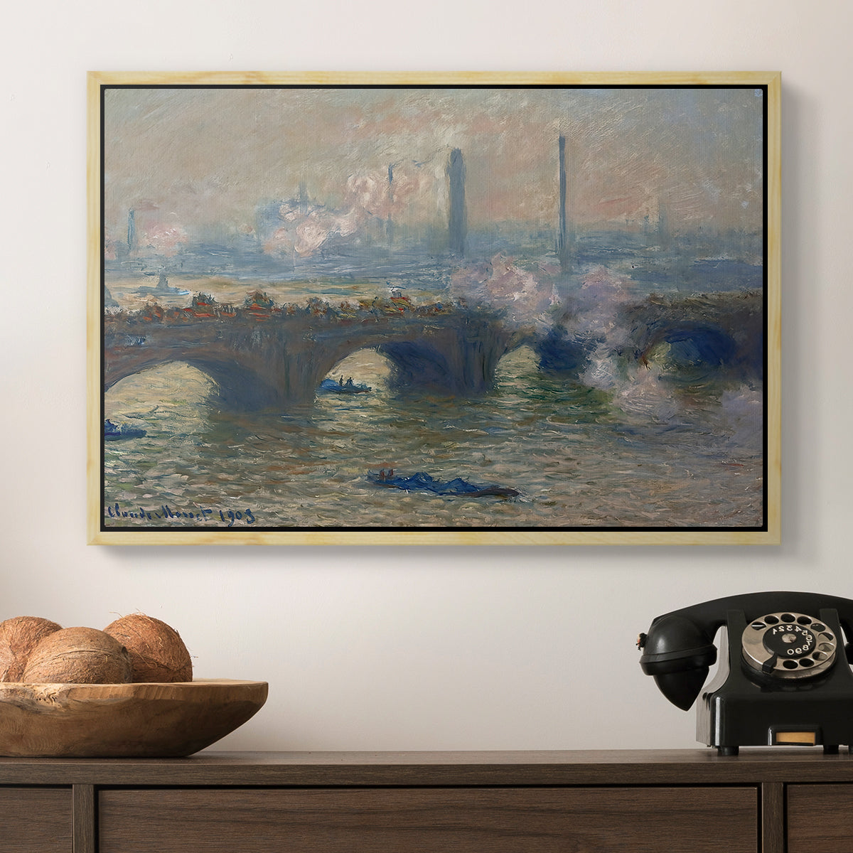 Waterloo Bridge, Gray Day, 1903 by Claude Monet in a natural wood floater framed canvas displayed above a console table in a hallway, featuring a foggy London bridge view with softened architectural forms.