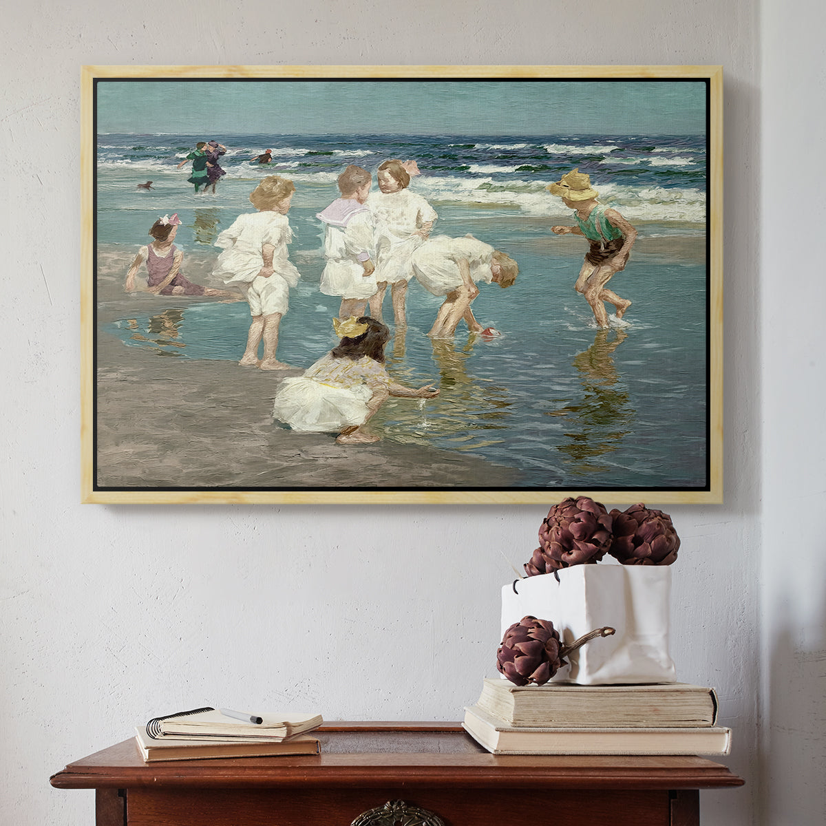 Natural wood floater framed canvas featuring A Holiday, c. 1915 by Edward Henry Potthast above an entryway table in a minimalist foyer.