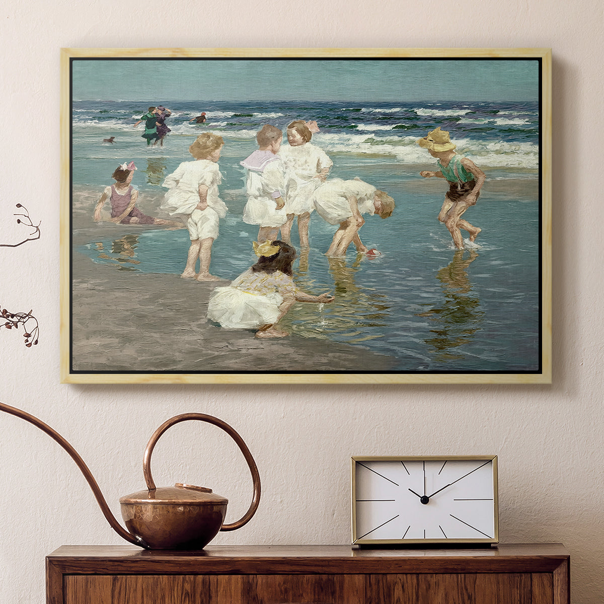 Natural wood floater framed canvas featuring an impressionist coastal view of families enjoying seaside water, displayed above a cabinet in a soft-toned living room.