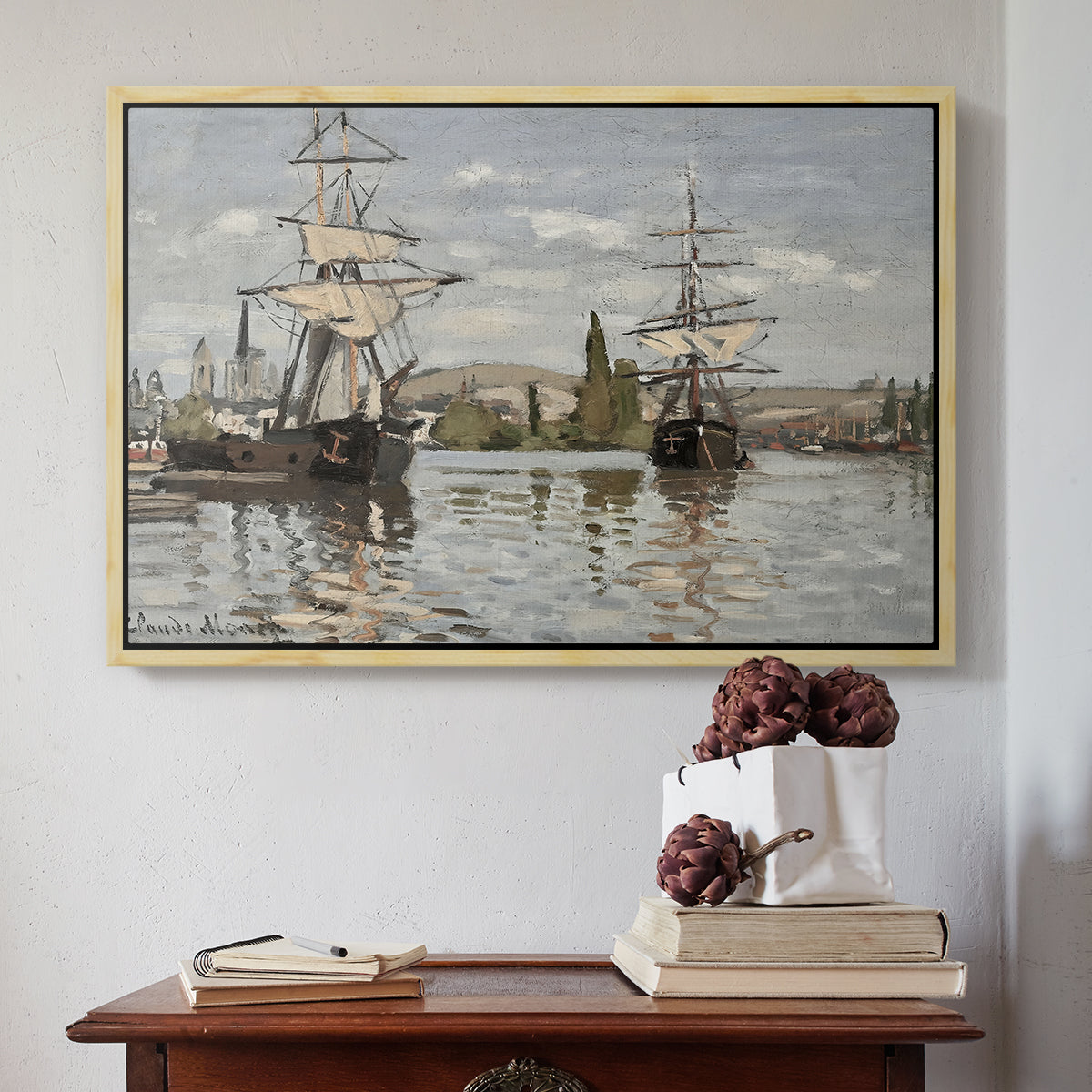 Natural wood floater framed canvas featuring Ships Riding on the Seine at Rouen, 1872 by Claude Monet above an entryway table in a minimalist foyer.