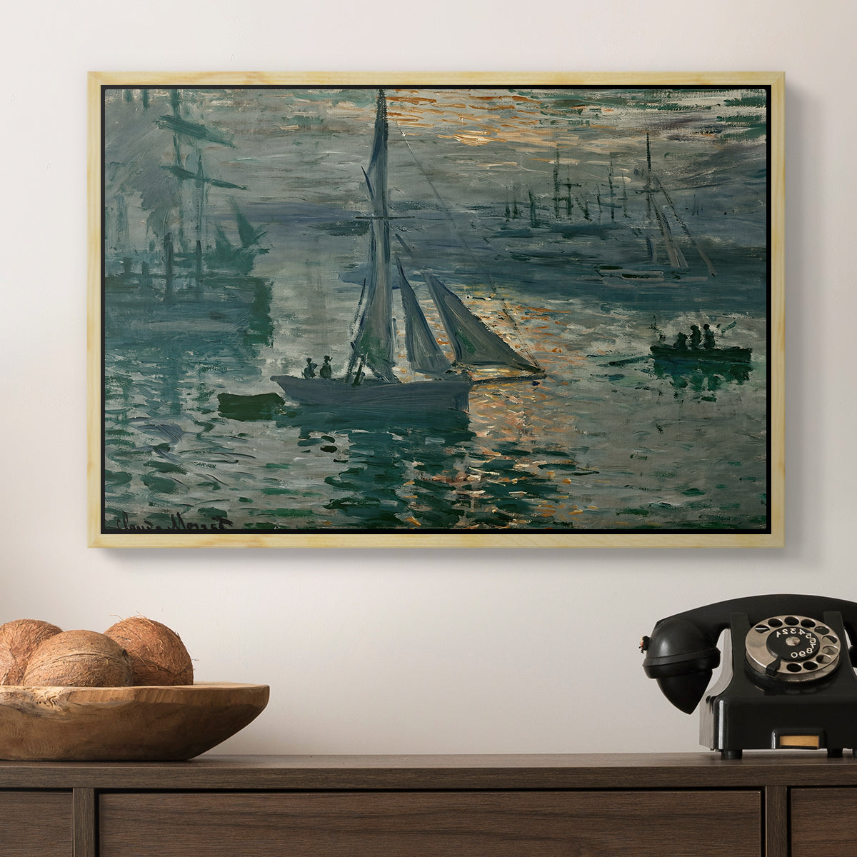 Sunrise (Marine), 1873 by Claude Monet in a natural wood floater framed canvas displayed above a console table in a hallway, featuring an atmospheric ocean view with sun rising through haze.