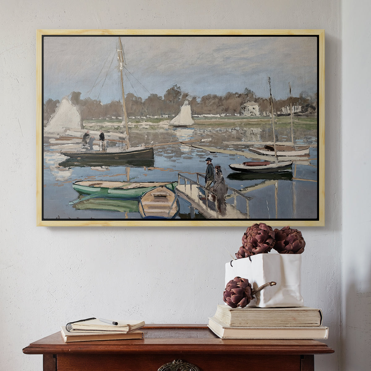 Natural wood floater framed canvas featuring The Basin at Argenteuil, 1874 by Claude Monet above an entryway table in a minimalist foyer.