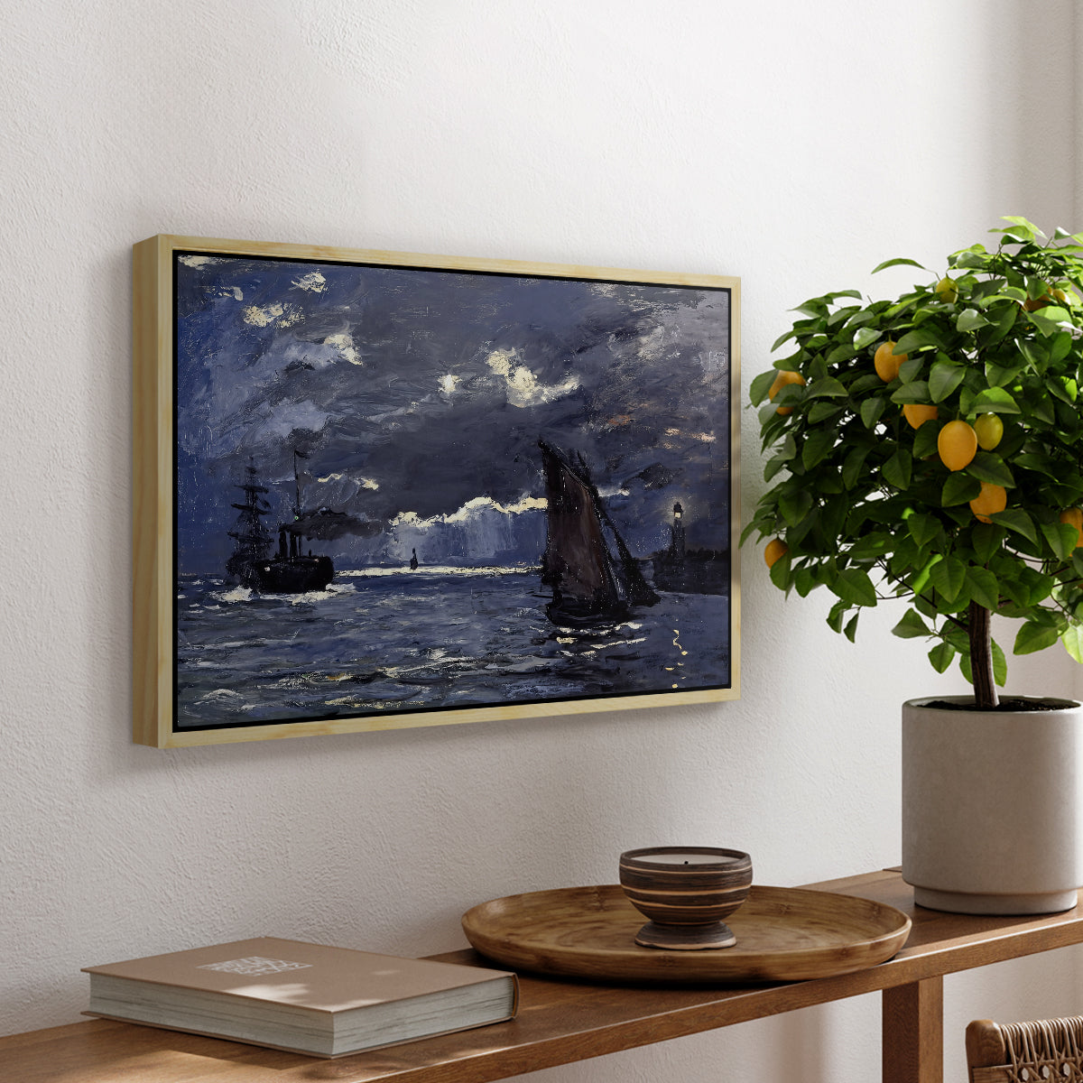 A Seascape, Shipping by Moonlight, 1864 by Claude Monet, presented in a natural wood floater framed canvas featuring ships on dark sea illuminated by moonlight under night sky, displayed above a hallway console table.