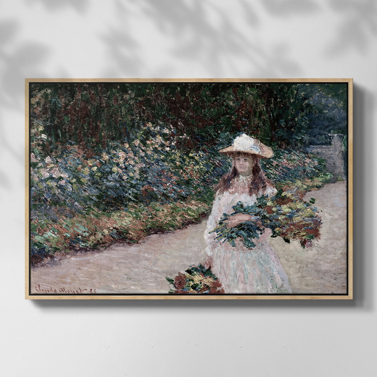 Front view of Young Girl in the Garden at Giverny, 1888 by Claude Monet in a natural wood floater framed canvas.