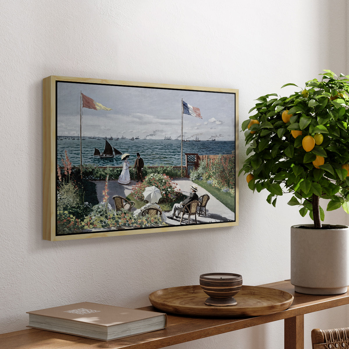 Garden at Sainte-Adresse, 1867 by Claude Monet, presented in a natural wood floater framed canvas featuring a seaside garden with flowers, flags, and figures overlooking the water, displayed above a hallway console table.