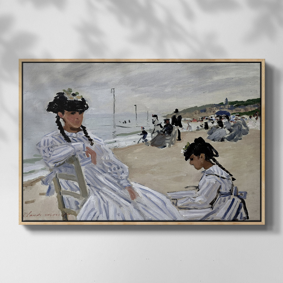 Front view of On the Beach at Trouville, 1870 by Claude Monet in a natural wood floater framed canvas.