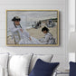 On the Beach at Trouville, 1870 by Claude Monet displayed above a sofa in a living room in a natural wood floater frame, featuring an impressionist seaside scene with women in dresses and hats.