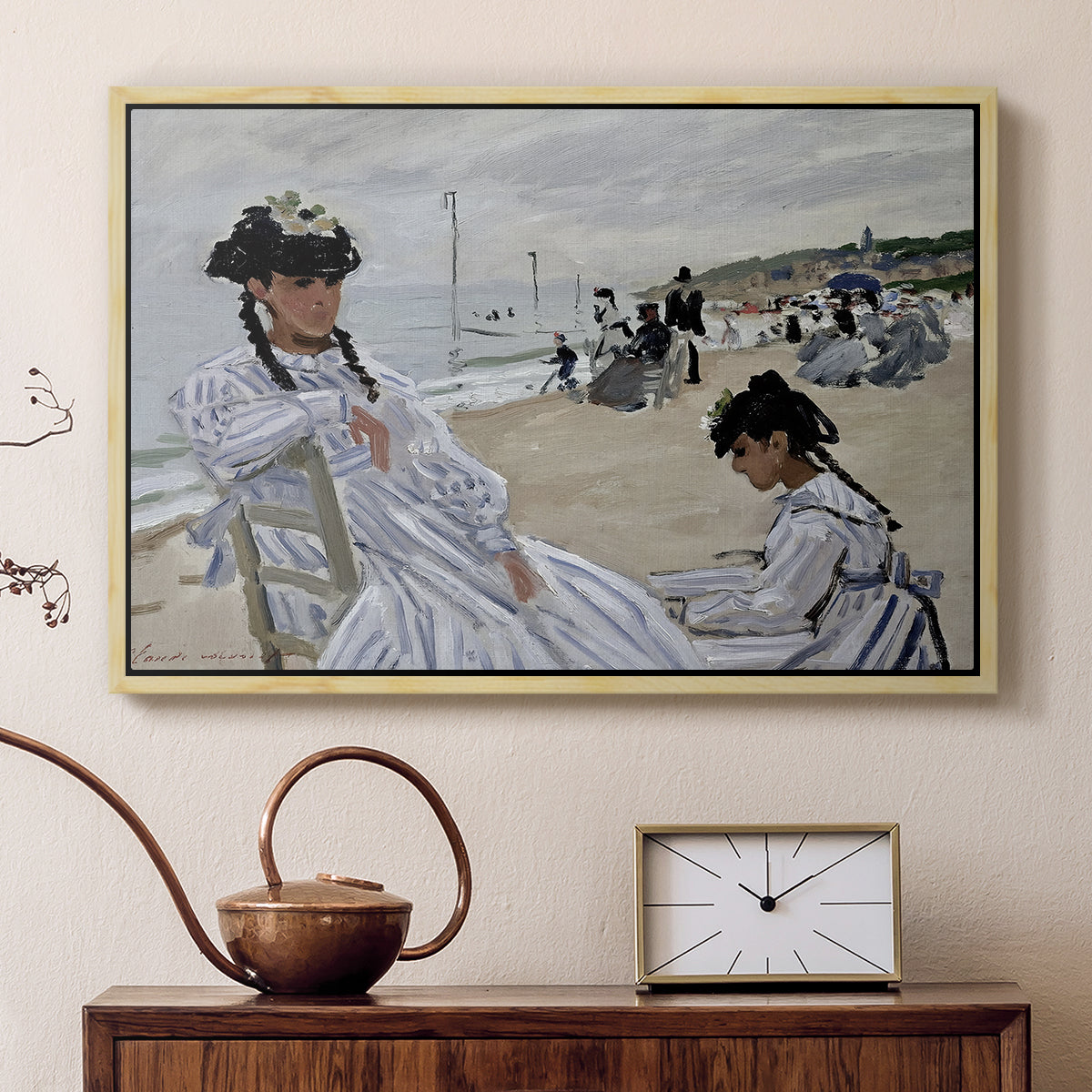 Natural wood floater framed canvas featuring a beach setting with people relaxing under umbrellas, displayed above a cabinet in a soft-toned living room.
