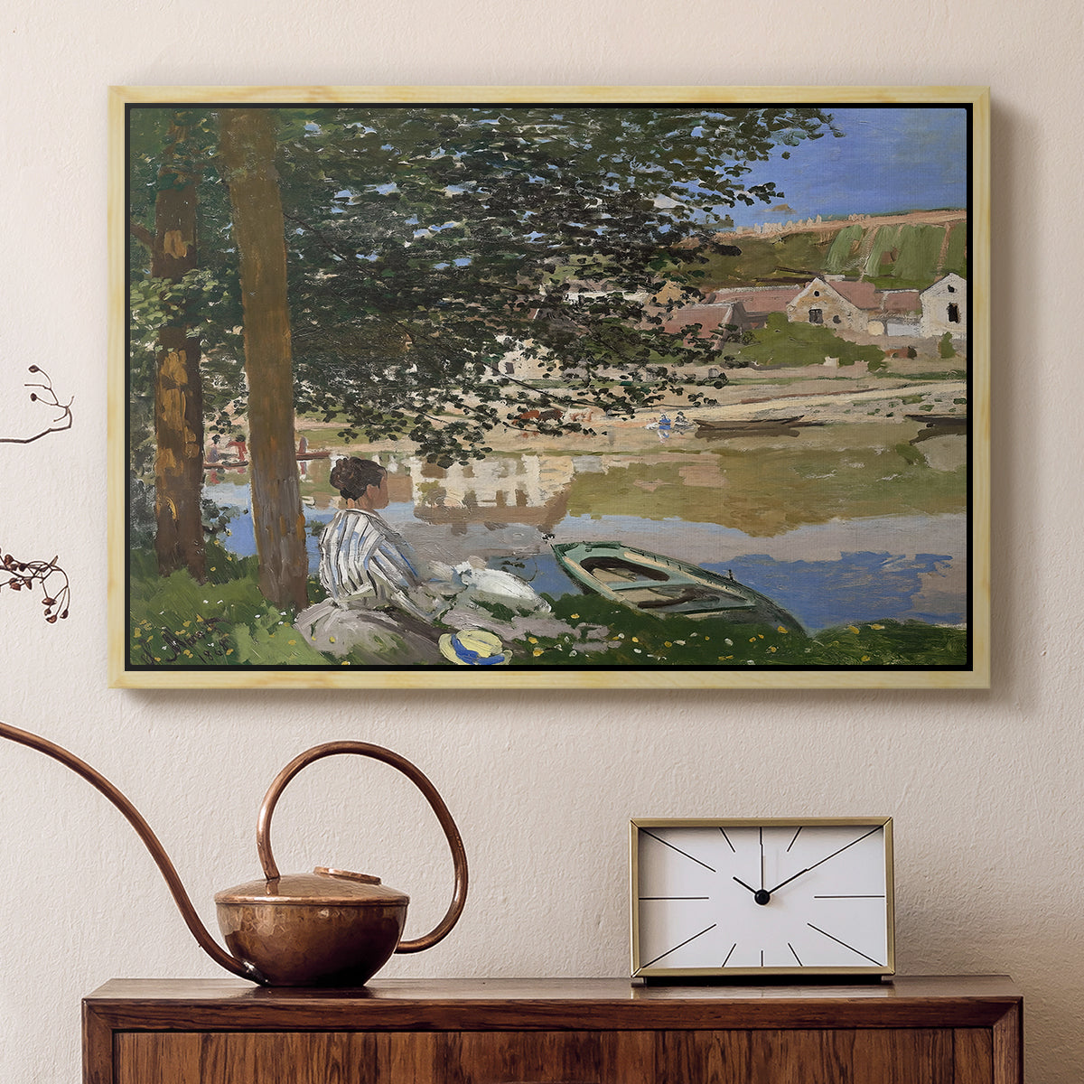 Natural wood floater framed canvas featuring an impressionist landscape with people relaxing along the Seine, displayed above a cabinet in a soft-toned living room.