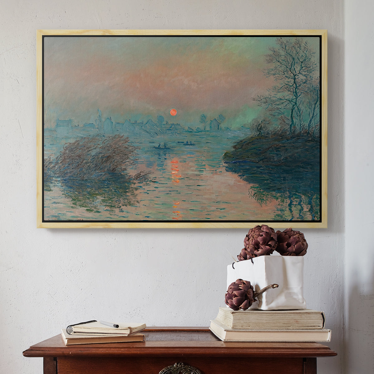 Natural wood floater framed canvas featuring Sunset on the Seine at Lavacourt, Winter Effect, 1880 by Claude Monet above an entryway table in a minimalist foyer.