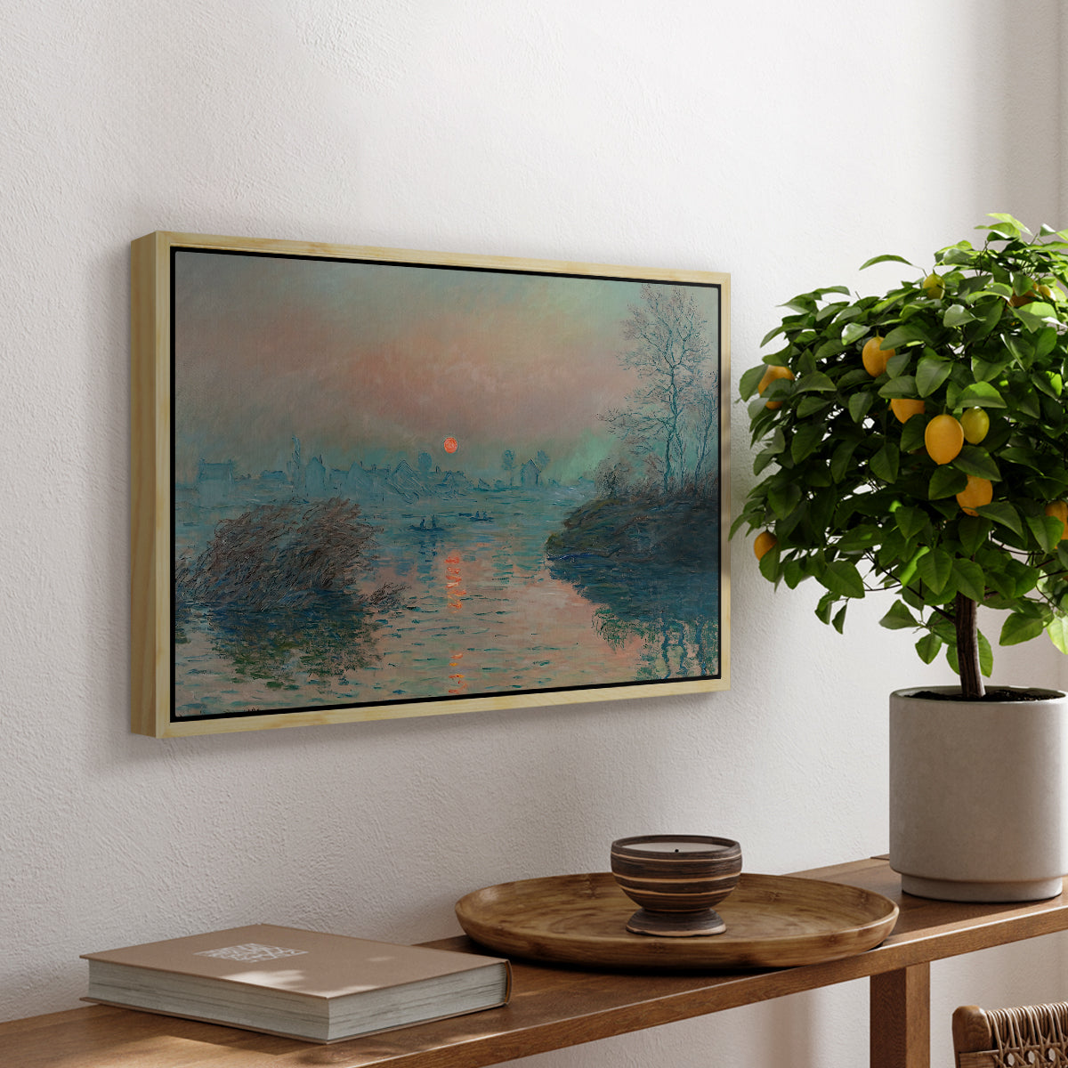Sunset on the Seine at Lavacourt, Winter Effect, 1880 by Claude Monet, presented in a natural wood floater framed canvas featuring a glowing sunset over snowy river landscape with soft reflections, displayed above a hallway console table.